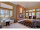 Inviting living room with a stone fireplace, large windows, and comfortable seating at 2828 Keystone Dr, Evergreen, CO 80439