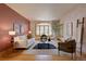 Bright living room with large windows, hardwood floors, neutral decor, and stylish furniture at 2828 Keystone Dr, Evergreen, CO 80439