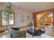 Stylish living room featuring hardwood floors, arched doorway, contemporary decor, and comfortable seating at 2828 Keystone Dr, Evergreen, CO 80439