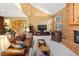 Cozy living room with vaulted ceilings, stone fireplace, comfortable leather furniture, and a spiral staircase at 2828 Keystone Dr, Evergreen, CO 80439