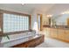 Lovely bathroom with large bathtub with custom tile surround, double sink vanity, and natural light at 2828 Keystone Dr, Evergreen, CO 80439
