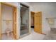 Large main bathroom with custom glass enclosed shower, toilet room, and vanity with granite countertop at 2828 Keystone Dr, Evergreen, CO 80439