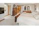 Bedroom with neutral walls and carpet, featuring a large bed, wooden furniture, and access to various rooms at 2828 Keystone Dr, Evergreen, CO 80439