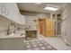Large mud room with custom cabinets, countertop, utility sink, and storage; adjacent to laundry at 2828 Keystone Dr, Evergreen, CO 80439