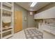 Functional mud room with utility sink, granite countertop, storage, and access to the exterior at 2828 Keystone Dr, Evergreen, CO 80439