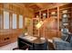 Executive office with rich wood finishes, built-in shelving, and natural light at 2828 Keystone Dr, Evergreen, CO 80439