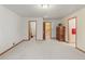 Large, bright room featuring neutral walls and carpet, multiple doorways, and ample space at 2828 Keystone Dr, Evergreen, CO 80439