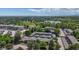 Aerial view of community, showcasing mature trees, lake, building and ample parking at 400 S Balsam St, Lakewood, CO 80226