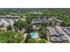 Aerial view shows community pool, lake, and greenery, providing a serene environment at 400 S Balsam St, Lakewood, CO 80226