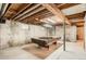 Unfinished basement with pool table offers potential for additional living or recreational space at 400 S Balsam St, Lakewood, CO 80226