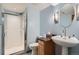 A blue bathroom features a shower and sink, with contemporary lighting and decor at 400 S Balsam St, Lakewood, CO 80226