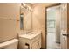 Bathroom featuring a white vanity with marble countertop, and a framed mirror with Hollywood lights at 400 S Balsam St, Lakewood, CO 80226