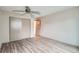 Bedroom with wood-style flooring, ceiling fan, a sliding door closet, and doorway at 400 S Balsam St, Lakewood, CO 80226