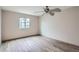 Cozy bedroom featuring wood-style floors, a ceiling fan, and window providing natural light at 400 S Balsam St, Lakewood, CO 80226