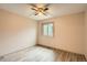 Clean bedroom with wood-style floors, ceiling fan, and plenty of natural light from a window at 400 S Balsam St, Lakewood, CO 80226