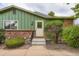 Exterior view of home with updated features including brick accents, new windows, and landscaping at 400 S Balsam St, Lakewood, CO 80226