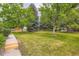 Expansive front lawn with mature trees offers shade and curb appeal to this property at 400 S Balsam St, Lakewood, CO 80226