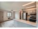 Open kitchen with gray cabinets, stainless appliances, and granite breakfast bar flows into dining area at 400 S Balsam St, Lakewood, CO 80226