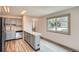 Updated kitchen featuring stainless steel appliances, granite countertops, and modern flooring at 400 S Balsam St, Lakewood, CO 80226