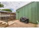 Back patio with brick pavers, fence, and grill offers an inviting outdoor space at 400 S Balsam St, Lakewood, CO 80226