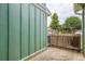 Side patio with green siding and wooden fence offers private outdoor space at 400 S Balsam St, Lakewood, CO 80226