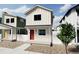 Charming two-story home featuring white siding, a red front door, and modern design elements at 13111 E 103Rd Pl, Commerce City, CO 80022