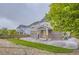 Beautiful backyard with well-maintained lawn, patio, and a charming two-story home at 6401 S Millbrook Way, Aurora, CO 80016