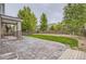Large backyard featuring a stamped concrete patio, grass lawn, and wood fence at 6401 S Millbrook Way, Aurora, CO 80016