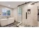 Stunning bathroom featuring a glass shower with unique tile work, a modern soaking tub, and stylish fixtures at 6401 S Millbrook Way, Aurora, CO 80016