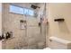 Modern shower featuring stylish tile work and glass door, complete with niche storage at 6401 S Millbrook Way, Aurora, CO 80016
