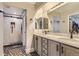 Elegant bathroom with double sinks, marble countertops, and a modern tiled shower at 6401 S Millbrook Way, Aurora, CO 80016