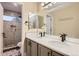 Bright bathroom with a dual-sink vanity, updated fixtures, and a view of the glass shower at 6401 S Millbrook Way, Aurora, CO 80016