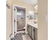 Well-lit bathroom with a double vanity, an open-door glass shower featuring modern fixtures at 6401 S Millbrook Way, Aurora, CO 80016
