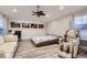 Bright bedroom with a bed, sofa, desk, massage chair, and modern decor at 6401 S Millbrook Way, Aurora, CO 80016