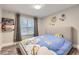 Cozy bedroom featuring a comfortable bed with fun space-themed decor and a bright window at 6401 S Millbrook Way, Aurora, CO 80016