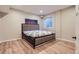 Comfortable bedroom with warm wood floors, a cozy bed, and a bright window at 6401 S Millbrook Way, Aurora, CO 80016