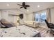 Bright bedroom featuring a seating area, work space, bed and a massage chair at 6401 S Millbrook Way, Aurora, CO 80016