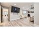 Large bedroom featuring wood-look floors, an entertainment center, and bright natural light at 6401 S Millbrook Way, Aurora, CO 80016