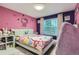 Whimsical pink and purple bedroom featuring Hello Kitty accents and a cozy beanbag chair at 6401 S Millbrook Way, Aurora, CO 80016
