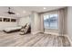 Spacious bedroom featuring wood-look floors, a ceiling fan, and bright natural light at 6401 S Millbrook Way, Aurora, CO 80016