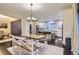 Inviting dining area featuring a wood table with benches, flowing into a bright, modern kitchen at 6401 S Millbrook Way, Aurora, CO 80016