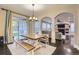 Open dining area with a light wood table, benches, and a view into the cozy living room at 6401 S Millbrook Way, Aurora, CO 80016
