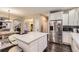 Open concept kitchen with stainless steel appliances, white cabinets, and a large island at 6401 S Millbrook Way, Aurora, CO 80016