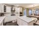 Open kitchen with stainless appliances, white cabinets, and access to the dining area at 6401 S Millbrook Way, Aurora, CO 80016