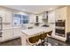 The kitchen features an island, stainless steel appliances, and white cabinets at 6401 S Millbrook Way, Aurora, CO 80016