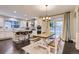 Bright open kitchen to dining room with stainless appliances, white counters and cabinetry at 6401 S Millbrook Way, Aurora, CO 80016