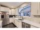 Bright kitchen with marble backsplash and stainless steel appliances at 6401 S Millbrook Way, Aurora, CO 80016