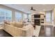 Inviting living room with a large sectional couch, fireplace, hardwood floors, and a ceiling fan at 6401 S Millbrook Way, Aurora, CO 80016
