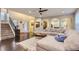 Spacious living room boasts hardwood floors, arched doorways, and an expansive sectional couch at 6401 S Millbrook Way, Aurora, CO 80016