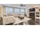 Bright living room with a cozy fireplace, large sectional couch, and lots of natural light at 6401 S Millbrook Way, Aurora, CO 80016